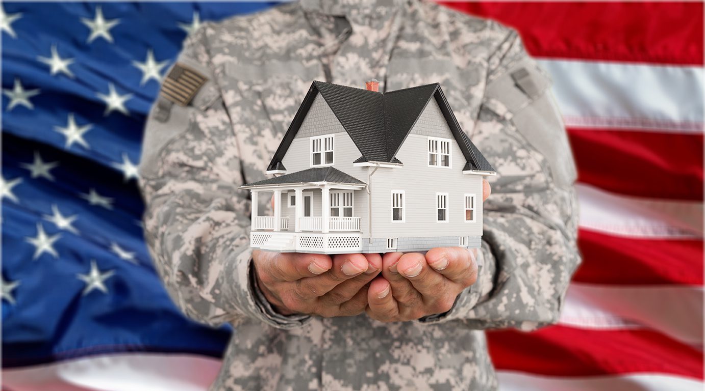 Military Vet holding house in hands